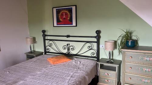 a bedroom with a bed with an orange pillow on it at Monte Paradiso Agriturismo in Pietralunga