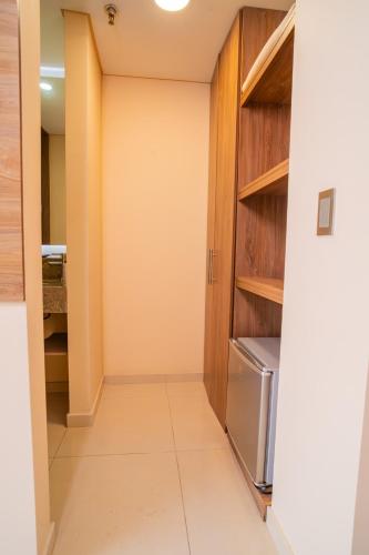 a walk in pantry in a kitchen with wooden cabinets at Ambar Hotel Boutique Cali in Cali