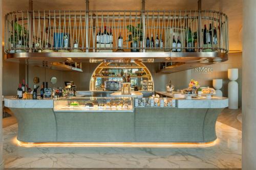 a restaurant with a bar with a lot of drinks at Sheraton Jumeirah Beach Resort in Dubai