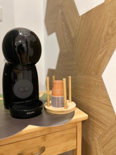 a coffee maker sitting on top of a wooden table at Appartamento Eden Green in Sulmona