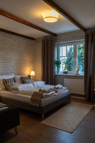 a large bed in a room with a window at Villa la Olive Premium Apartaments-Luxury Standard in Oświęcim