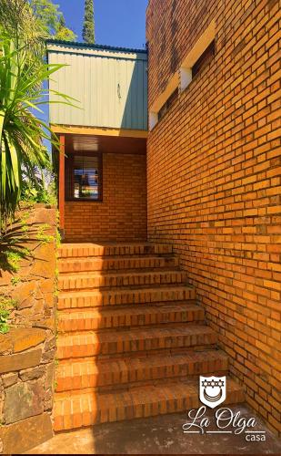 a brick building with stairs in front of it at Casa LA OLGA in Eldorado
