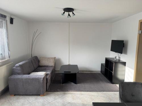 a living room with a couch and a tv at Wohlfühloase mit Wasserbett in Bodelshausen