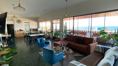 a living room with a couch and tables and chairs at Hotel La Casona del Desierto in Huasco