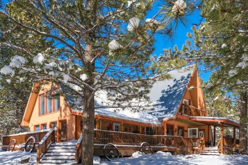 a house with snow on the roof at Angel Fire Cabin in Angel Fire