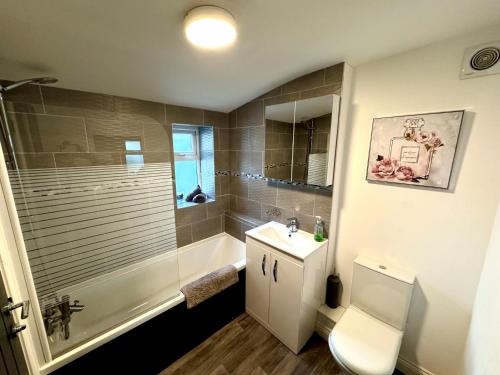 a bathroom with a shower and a toilet and a sink at Edith Haven Tynemouth Fabulous Coastal Holiday Home with Free OnStreet Parking in Tynemouth