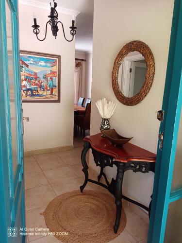 aoyer with a table and a mirror and a table at Coelacanth Sea & River Lodge in Kayserʼs Beach