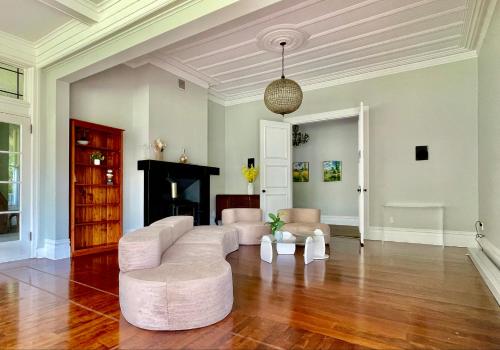 a living room with a couch and a fireplace at Winter Fun - Spa, Pinball, Billiard and more in Kumeu