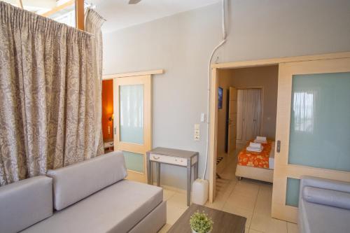 a living room with a couch and a bed at CORAL in Parga