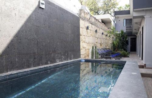 a swimming pool in the backyard of a house at Adhoc Boutique Barrio Antiguo in Monterrey