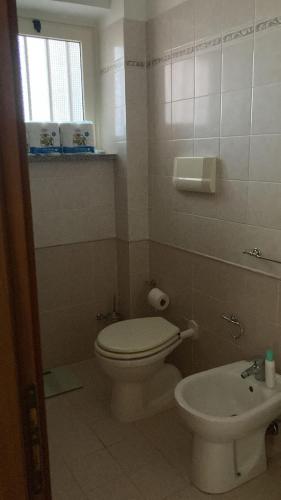 a small bathroom with a toilet and a sink at Casa da sogno sul mare in Bianco