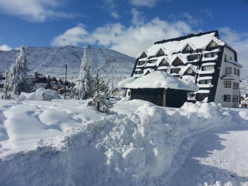 a pile of snow in front of a building at Village Catedral Hotel & Spa in San Carlos de Bariloche