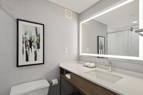 a bathroom with a sink and a mirror at Crowne Plaza Lansing by IHG in Lansing