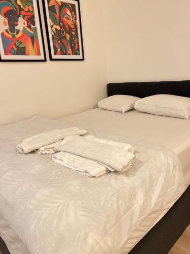a bed with a towel on it in a room at Brussels-Hôtel-appartement in Brussels