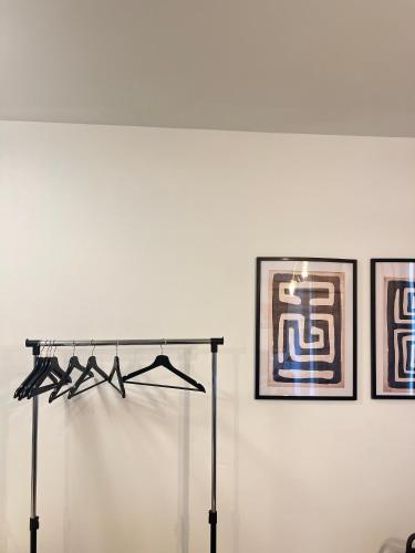 a white wall with two framed pictures on a wall at Brussels-Hôtel-appartement in Brussels