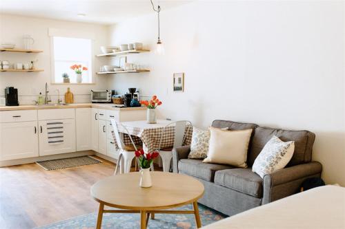 a living room with a couch and a table at The Cozy Cottage in Moscow