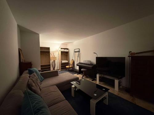 - un salon avec un canapé et un piano dans l'établissement 13 Rue Edith Cavell, à Cannes