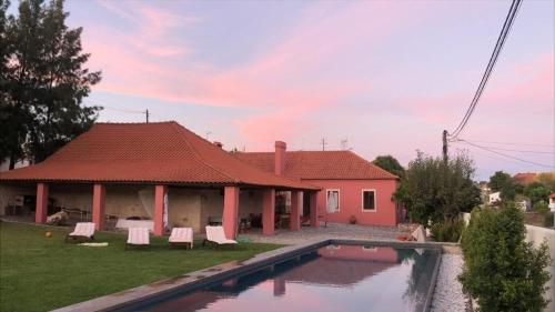 a house with a swimming pool in the yard at Casa da Mata in Torres Novas