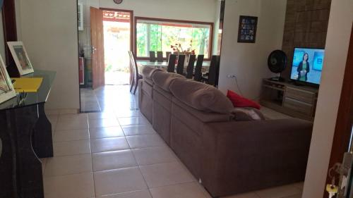 a living room with a couch and a television at Casa de Praia para Carnaval in Prado