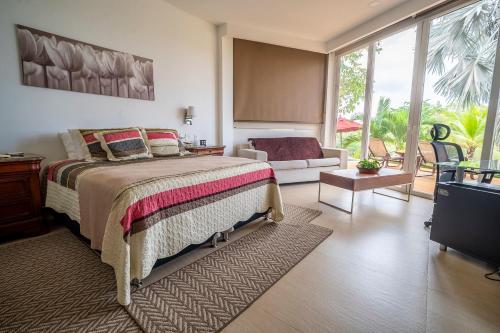 a bedroom with a large bed and a living room at wonderful house in Marina Baru in Cartagena! in Isla Barú