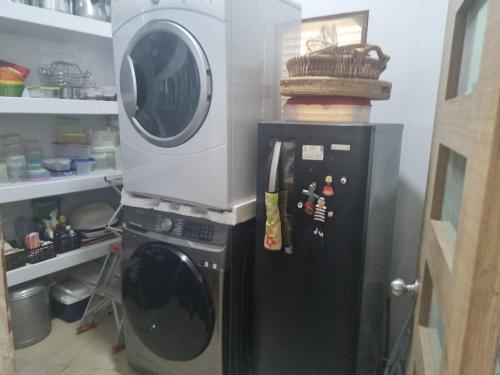 a microwave on top of a refrigerator in a kitchen at wonderful house in Marina Baru in Cartagena! in Isla Barú