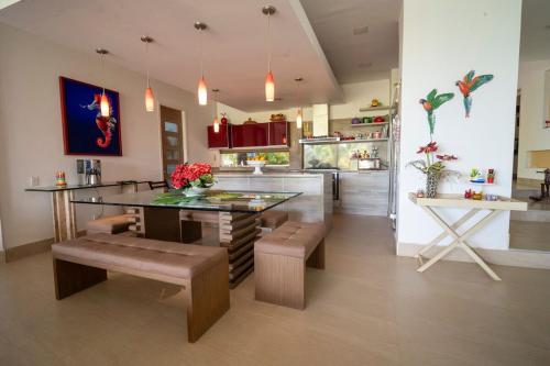 a kitchen with a table and some benches and a counter at wonderful house in Marina Baru in Cartagena! in Isla Barú