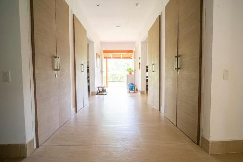 an empty hallway with wooden walls and floors and a hallway with wooden doors at wonderful house in Marina Baru in Cartagena! in Isla Barú