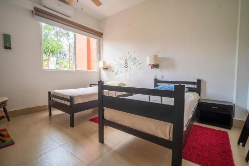 a bedroom with two bunk beds and a window at wonderful house in Marina Baru in Cartagena! in Isla Barú
