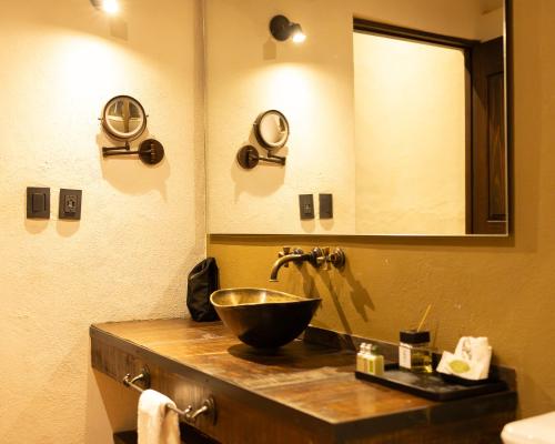 a bathroom with a bowl sink and a mirror at Hacienda El Salitre Hotel & Spa in Querétaro