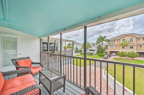 a balcony with a couch and chairs and a view of a yard at Waterfront Marco Island House with Shared Dock! in Marco Island