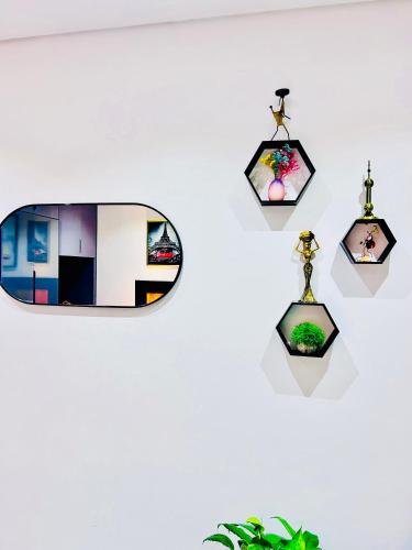 a wall with pictures and a mirror on a wall at Studio 19 Diamond-2bedroom apartment in Gaborone