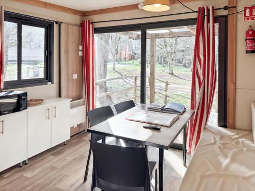an office with a table and chairs and a window at Le Nouméa, 4 pers, 3 lits in Saint-Pantaléon-de-Lapleau