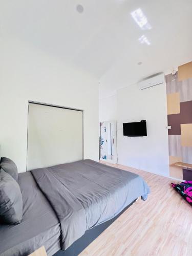 a bedroom with a large bed in a room at The Inside House Medewi in Airsatang