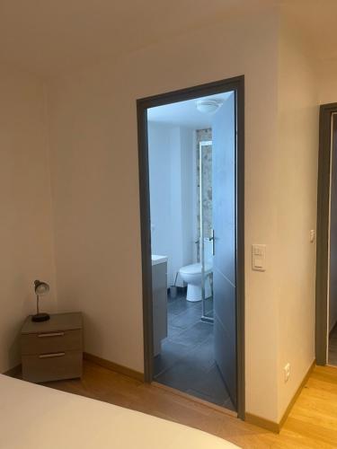 a bathroom with a glass door leading to a shower at Les Chambres d'Orsay in Orsay