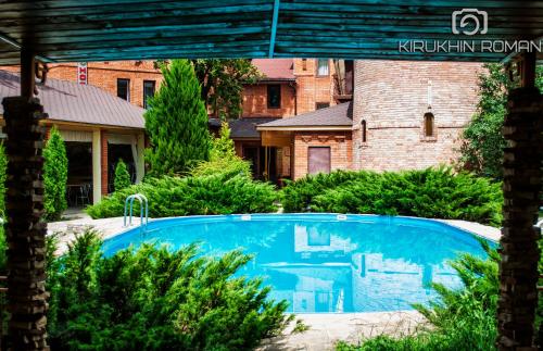 a swimming pool in the yard of a house at Britaniya in Kharkiv