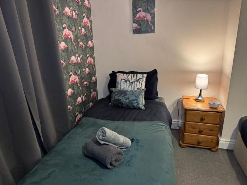 a small bedroom with a bed with towels on it at The Accrington Haven in Accrington