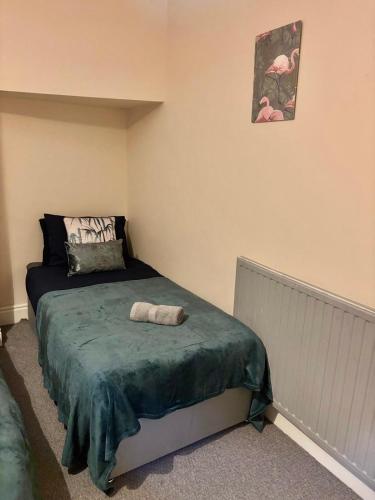 a bedroom with a bed with a towel on it at The Accrington Haven in Accrington