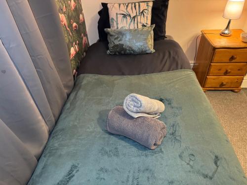 a bed with two towels on top of it at The Accrington Haven in Accrington