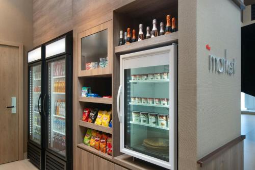 a refrigerator filled with lots of food in a store at Residence Inn by Marriott Santiago de los Caballeros in Santiago de los Caballeros