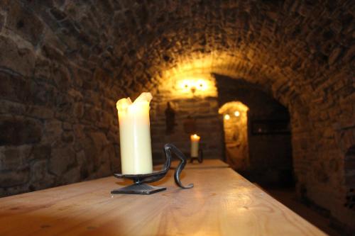 a candle sitting on top of a table in a tunnel at Drevenica in Oščadnica