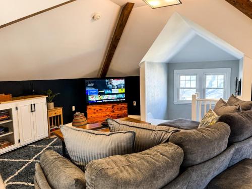 a living room with a couch and a tv at CRAFTSMAN UPSTAIRS with impressive attic! in Willmar
