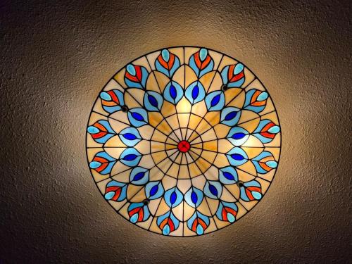 a ceiling light with a stained glass window on a ceiling at CRAFTSMAN UPSTAIRS with impressive attic! in Willmar