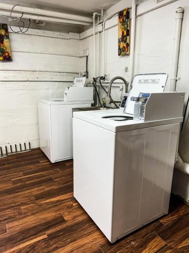 a kitchen with white appliances on a wooden floor at CRAFTSMAN UPSTAIRS with impressive attic! in Willmar