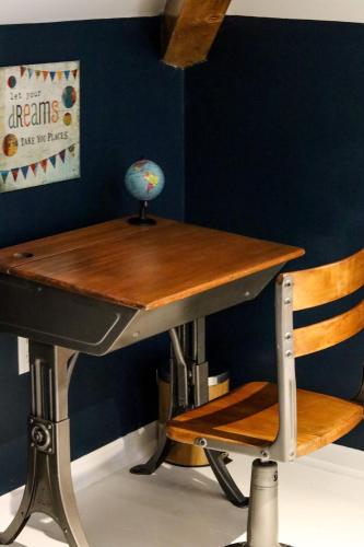 a desk and a chair with a table and a globe on it at CRAFTSMAN UPSTAIRS with impressive attic! in Willmar