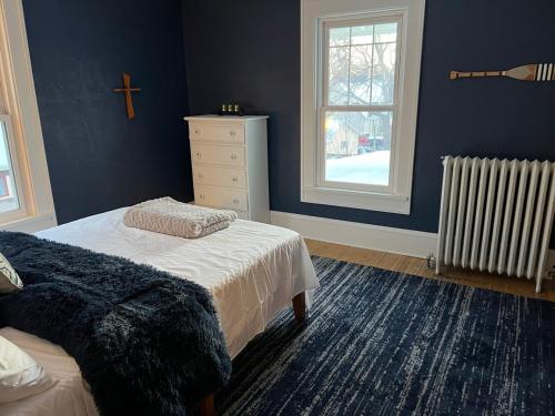 a bedroom with a bed and a cross on the wall at CRAFTSMAN UPSTAIRS with impressive attic! in Willmar