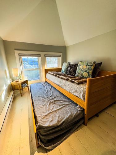 a large bed in a room with a window at CRAFTSMAN UPSTAIRS with impressive attic! in Willmar