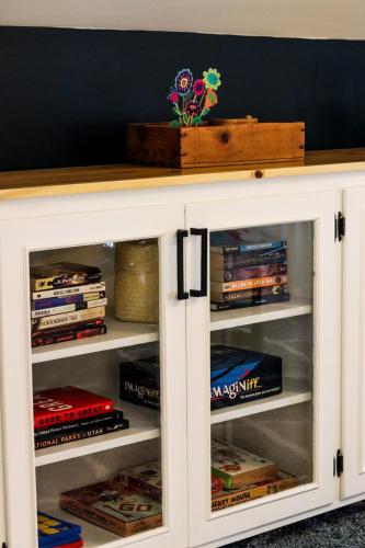 a white cabinet filled with books at CRAFTSMAN UPSTAIRS with impressive attic! in Willmar