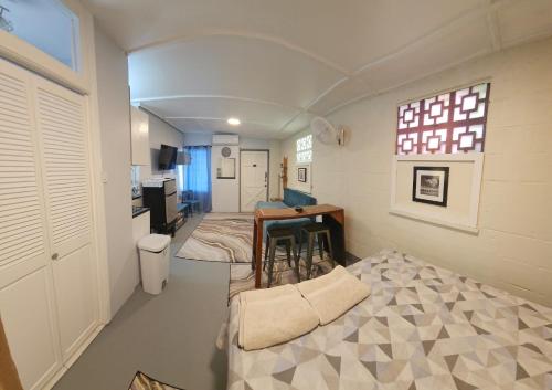 a room with a desk and a table in it at Gloria's Hideaway in Christ Church