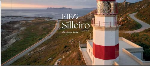 a red and white lighthouse on a hill with a road at Hotel Boutique Faro Silleiro in Baiona