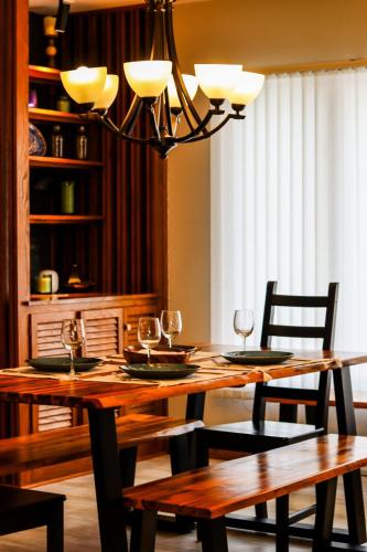 a dining room table with two chairs and a chandelier at MI CASA- 4 Bd- Mega Playground in Willmar